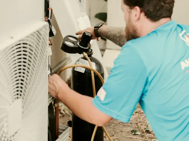 HVAC technician checking pressure gauges on an outdoor AC unit