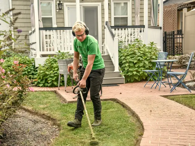 Landscaper edging the lawn of a front yard