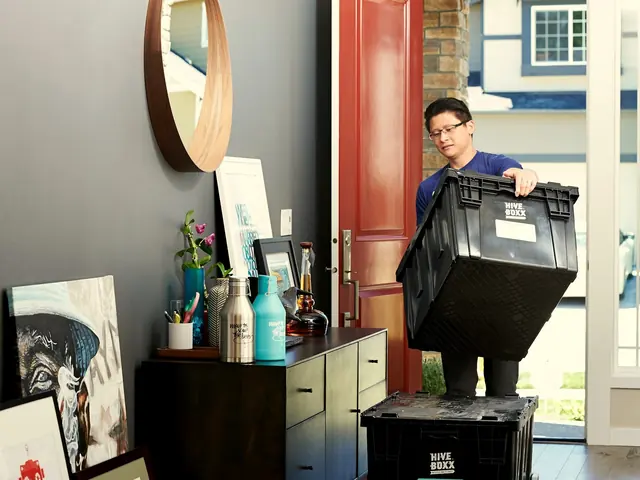 Mover carrying a crate through a front door