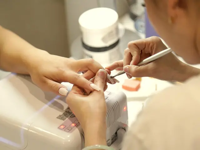 Nail technician shaping a client’s nails