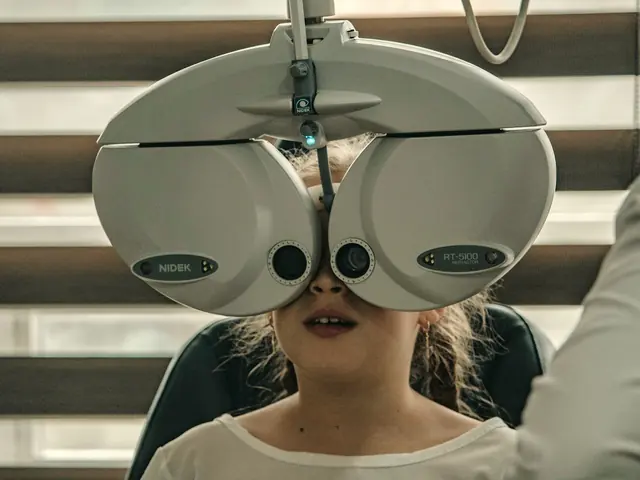 Patient looking through a phoropter during an eye exam